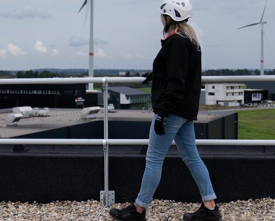 Woman next to roof top guardrails